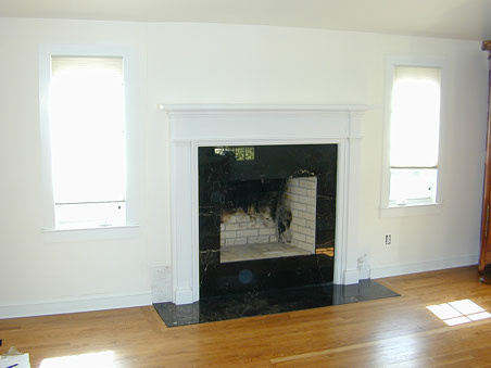 New york mantel in white made tall installed with black granite